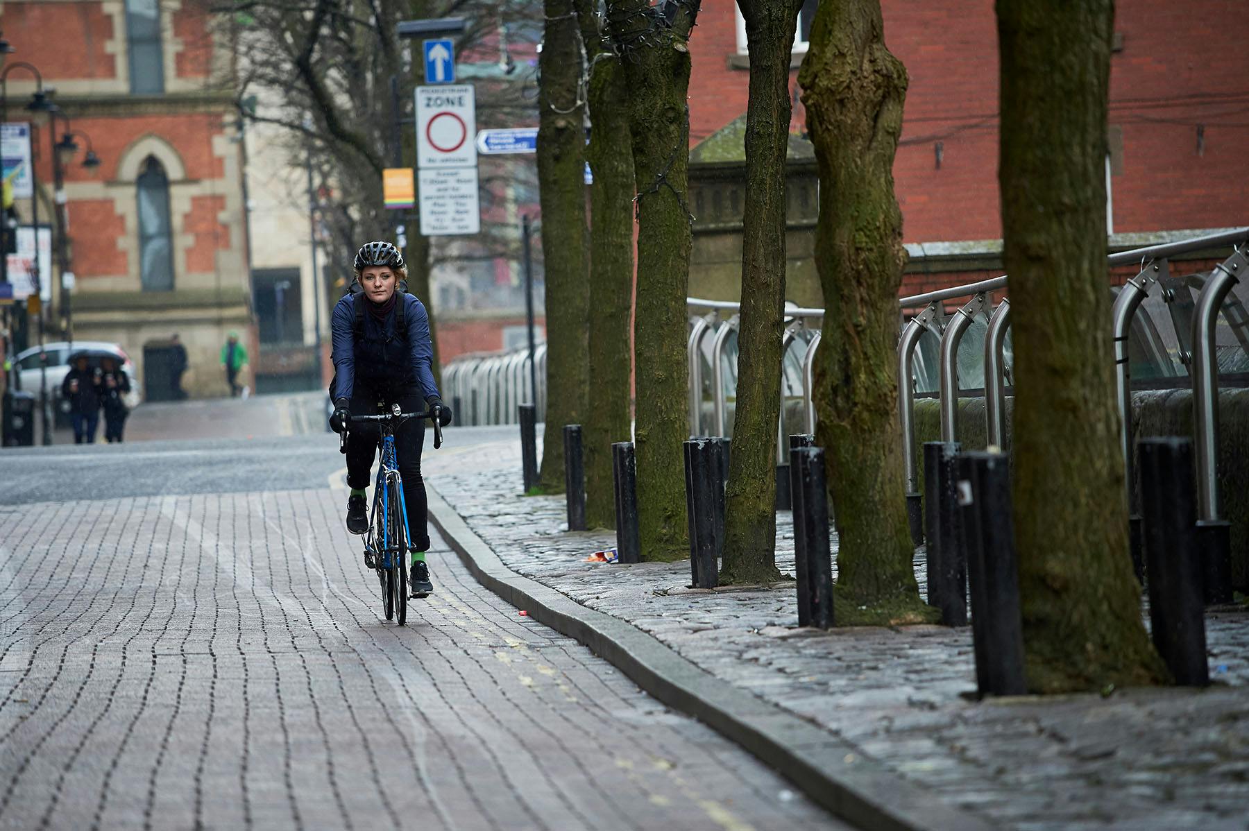 Person riding bike through a city centre