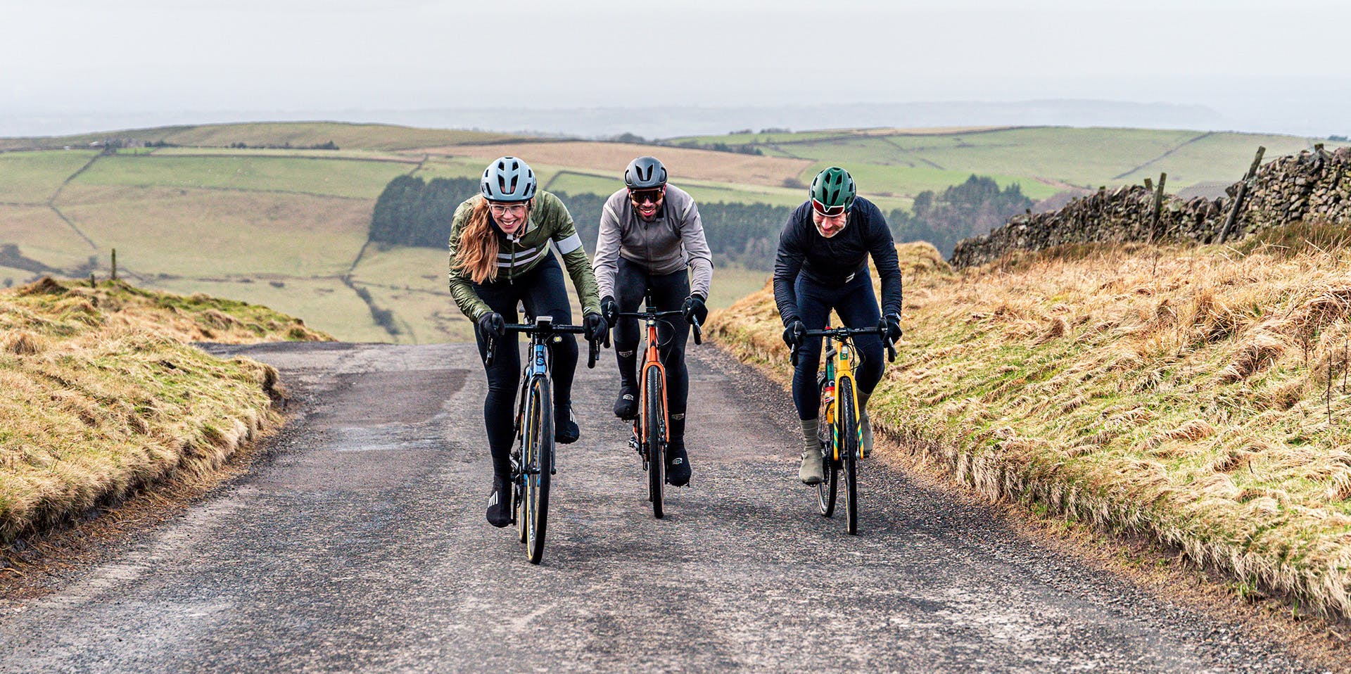 Three riders enjoying the end of a tough road climb